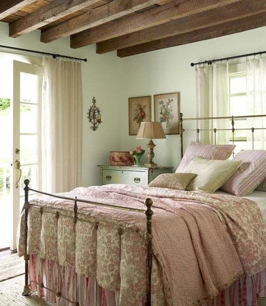 Mint-walls-wooden-beams-on-the-ceiling-and-floral-print-bedding.-1