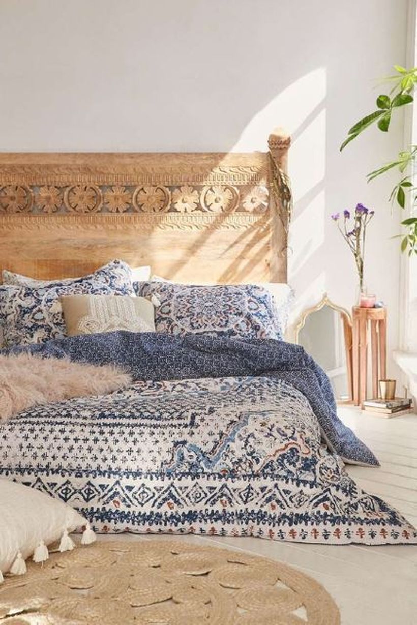 Unique-carved-wooden-backdrop-bed-and-small-night-stand-to-compliment-your-room-furniture-by-adding-unique-bed-linen-patterns-for-a-boho-style-touch