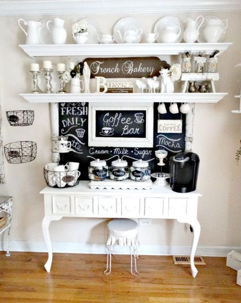 White coffee bar combined with a black board, unique white shelves and a small white chair