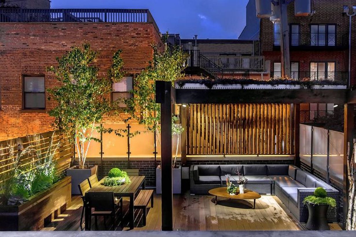 A-cozy-backyard-patio-deck-design-with-added-firing-lights-to-light-up-your-terrace-which-is-placed-on-the-pergola