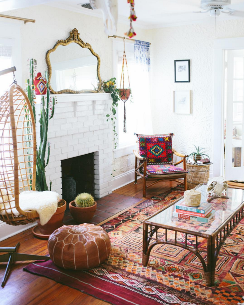 A-unique-living-room-a-boho-theme-looks-great-combined-with-colorful-boho-patterns-on-rugs-chairs-and-coffee-table-rattan