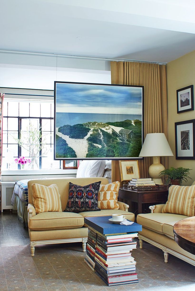 Beige-living-room-design-with-sofas-gallery-art-and-unique-coffee-tables-from-a-stack-of-books-for-your-inspiration-that-can-be-applied
