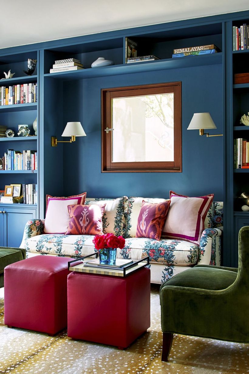 Clever-storage-bookcase-in-the-living-room-with-flower-pattern-sofa-and-red-coffee-table-from-leather-to-create-you-comfortable-being-in-this-room