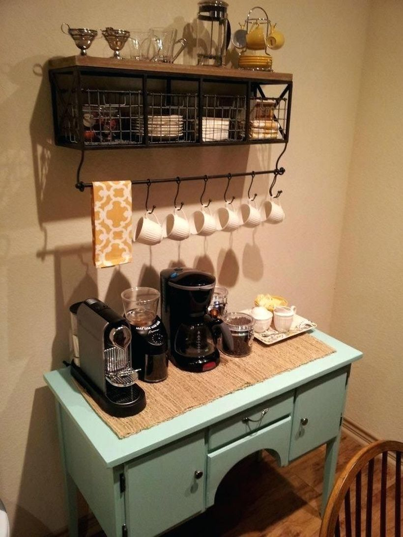 Coffee bar made of light blue wood combined with small drawers, wooden shelves and black iron