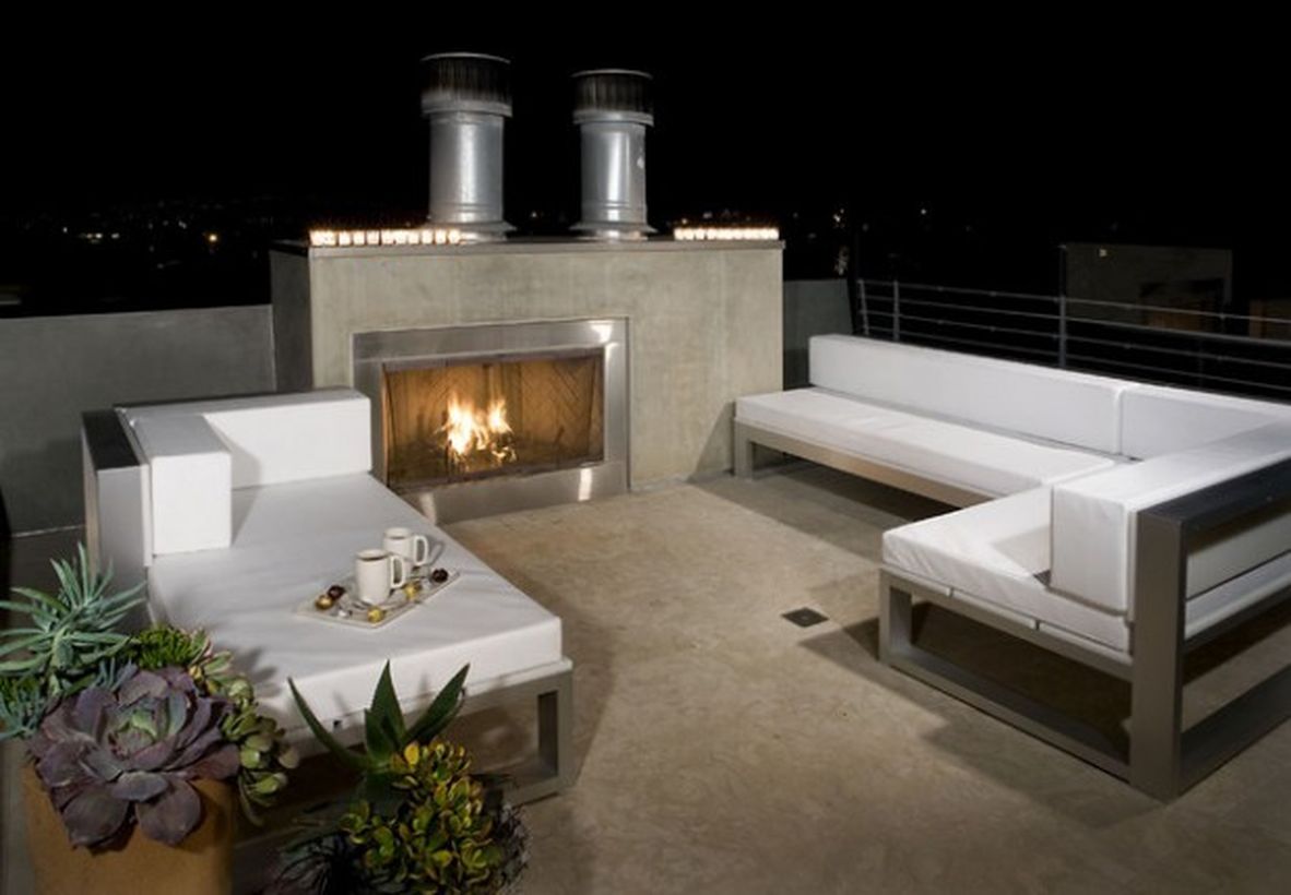 Comfortable-rooftop-design-with-fire-pit-and-white-sofas-to-relax-at-night-and-warm-up