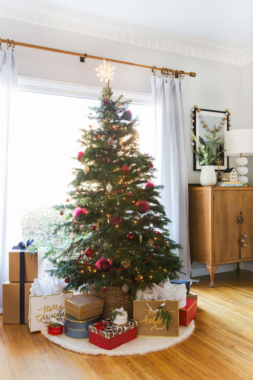 Green-chrismast-tree-with-red-bell-ornament-led-lighting-and-rattan-basket-for-chrismast-tree-conteiner