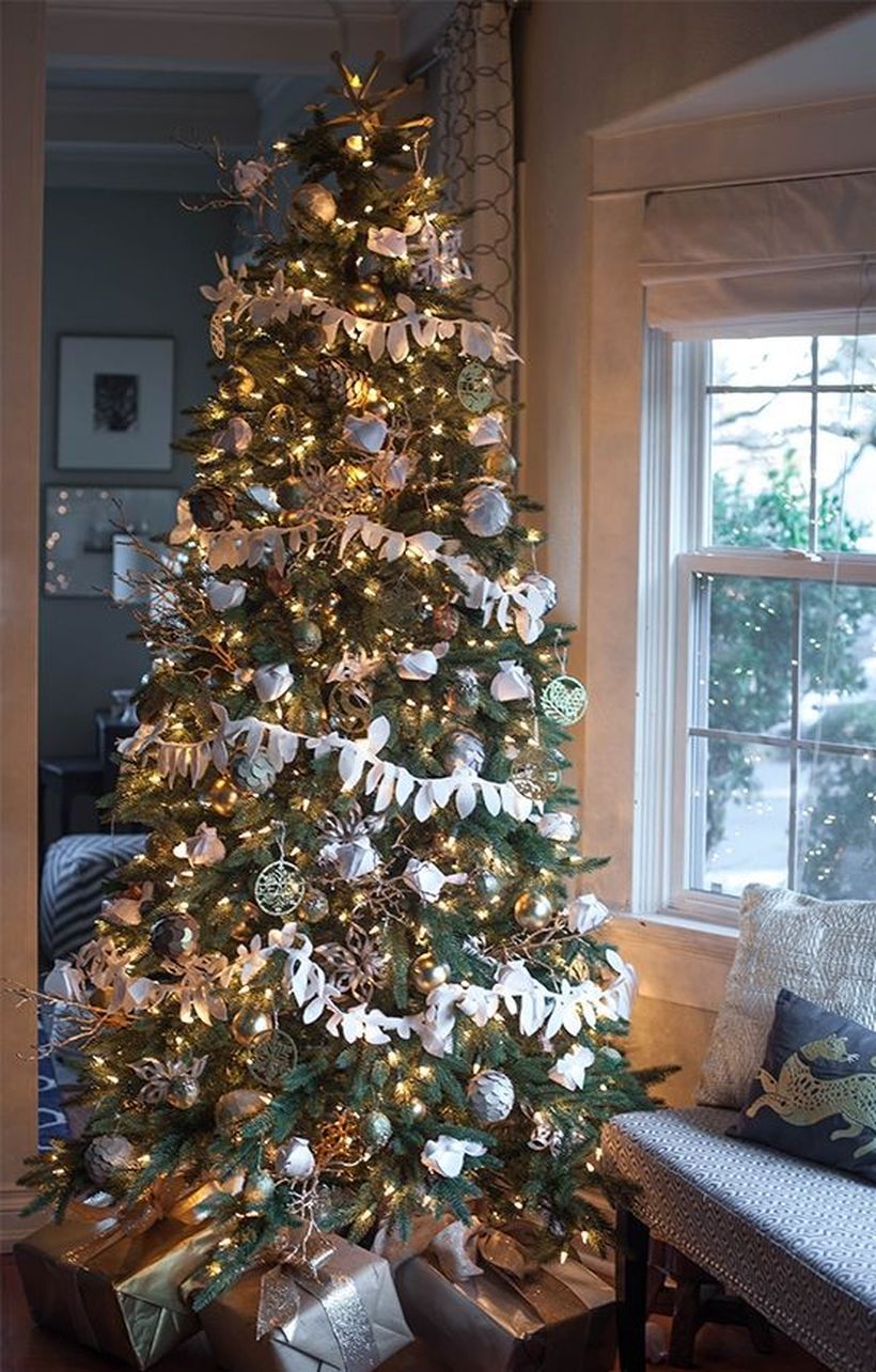 Green-christmas-tree-decoration-with-various-ornaments-that-are-characteristic-of-christmas-and-wrapped-in-white-crepe-paper-to-make-it-interesting