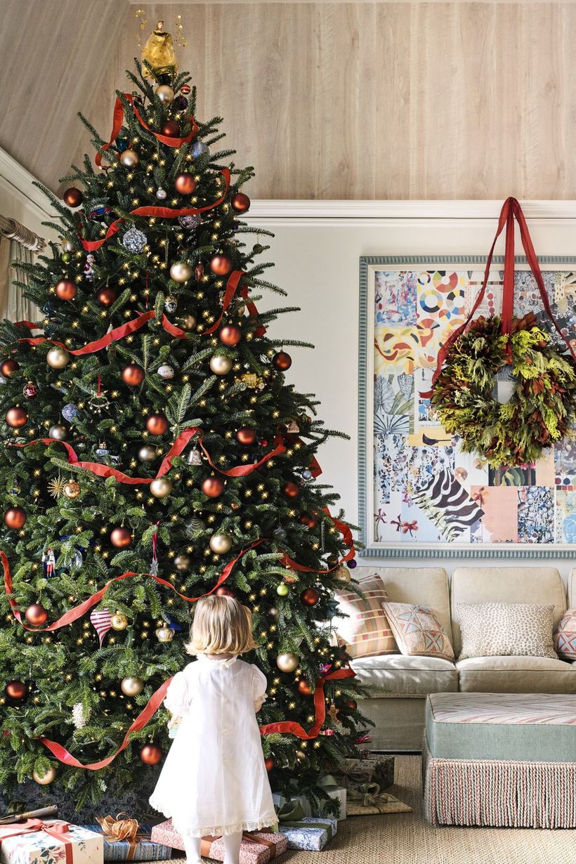 Green-christmas-tree-with-gold-bell-ornament-and-red-crepe-paper-to-decorate-the-tree-to-create-interesting