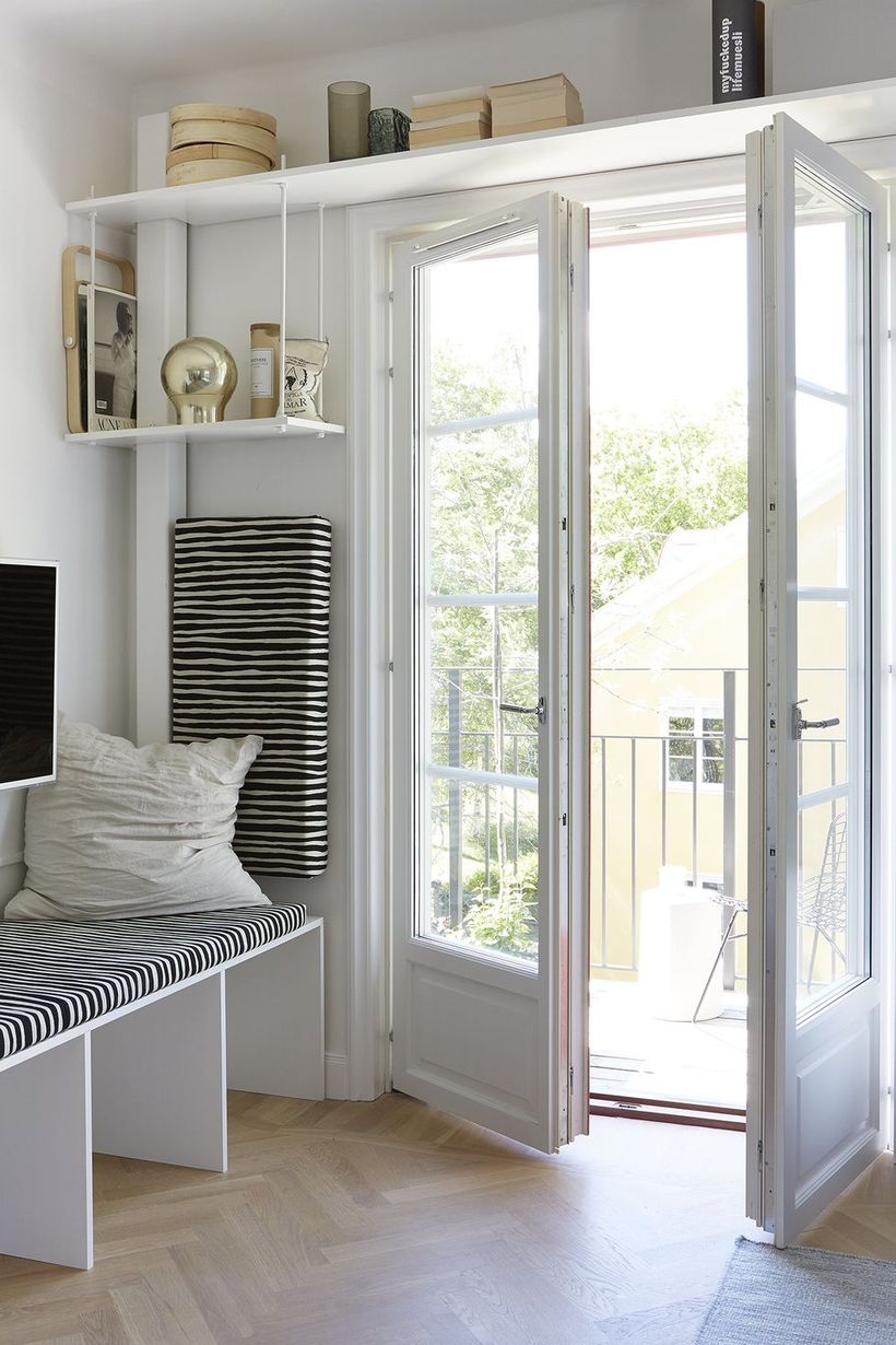 Inspired-comfortable-white-entryway-with-a-long-hanging-rack-above-the-door-to-store-some-small-objects
