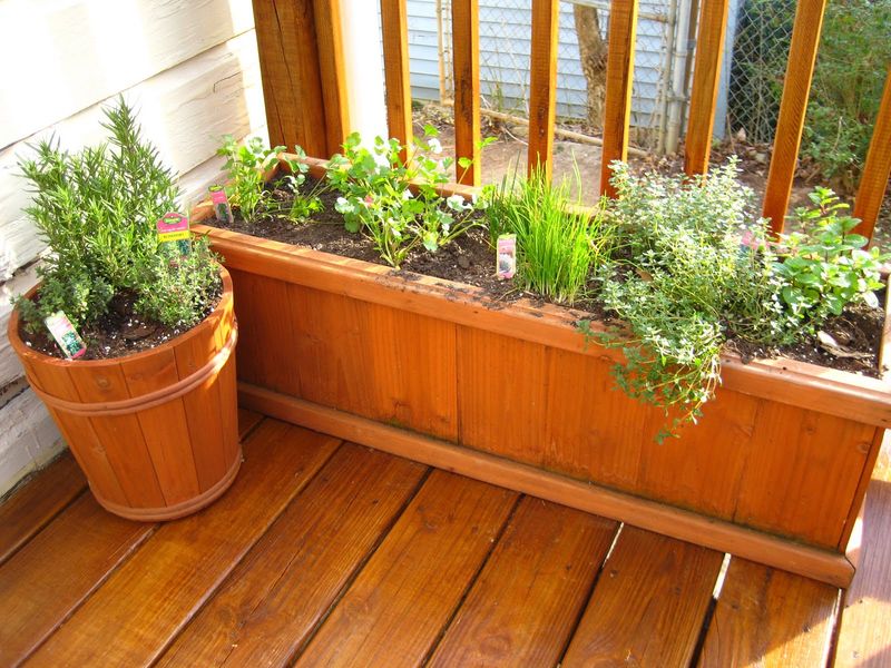 Interesting-balcony-garden-with-herb-and-a-place-use-recycled-wood-to-get-beauty-in-the-corner-of-the-balcony.