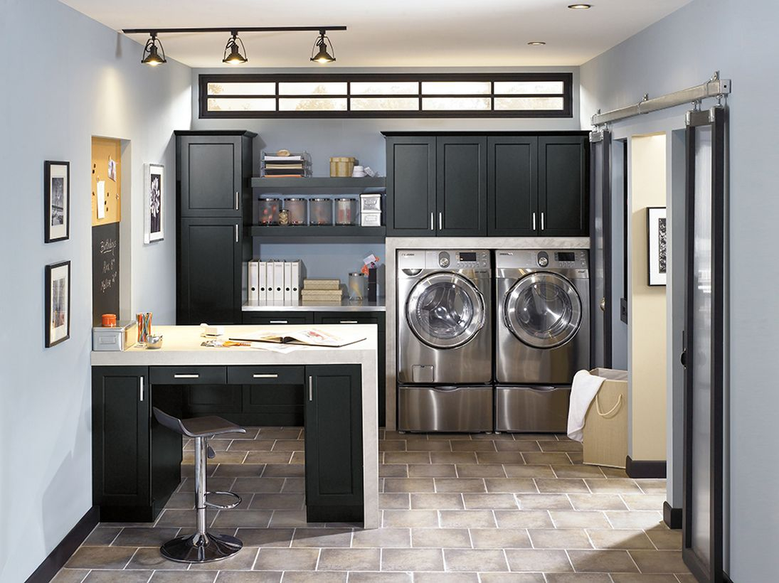 Laundry room with black cabinet and silver washing machine