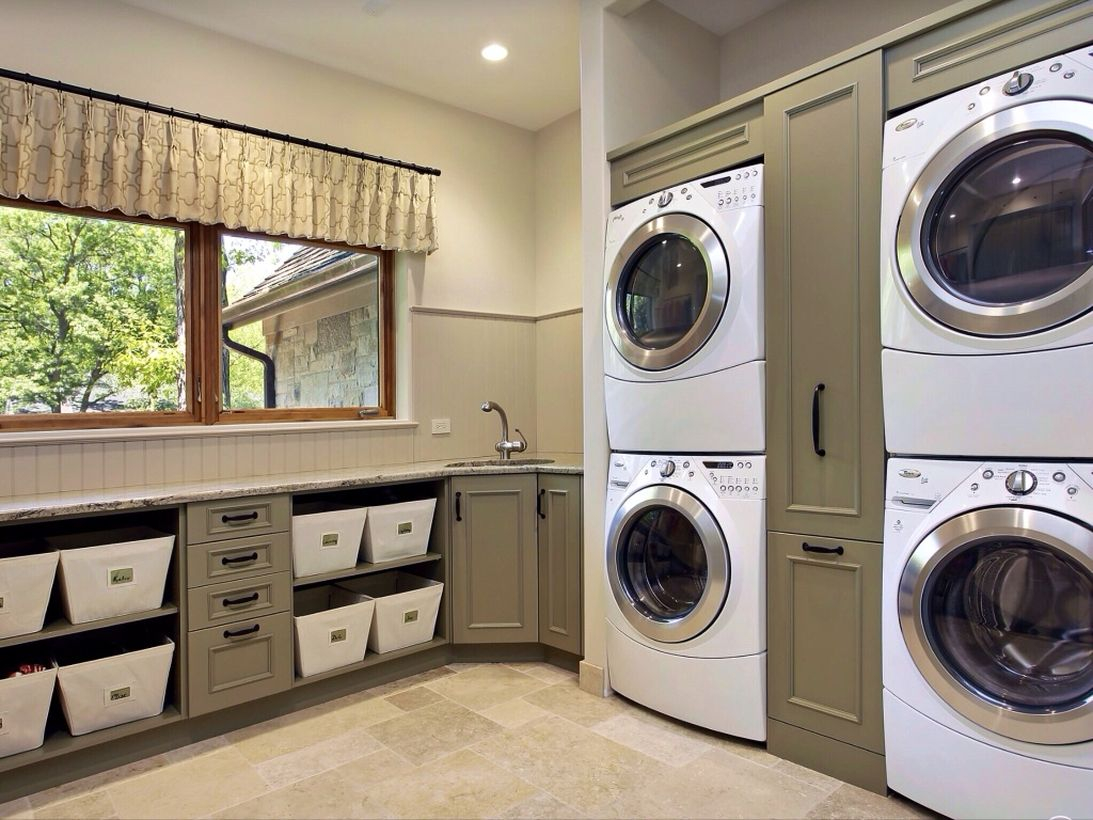 Laundry room with green cabinet and multi level washing machine