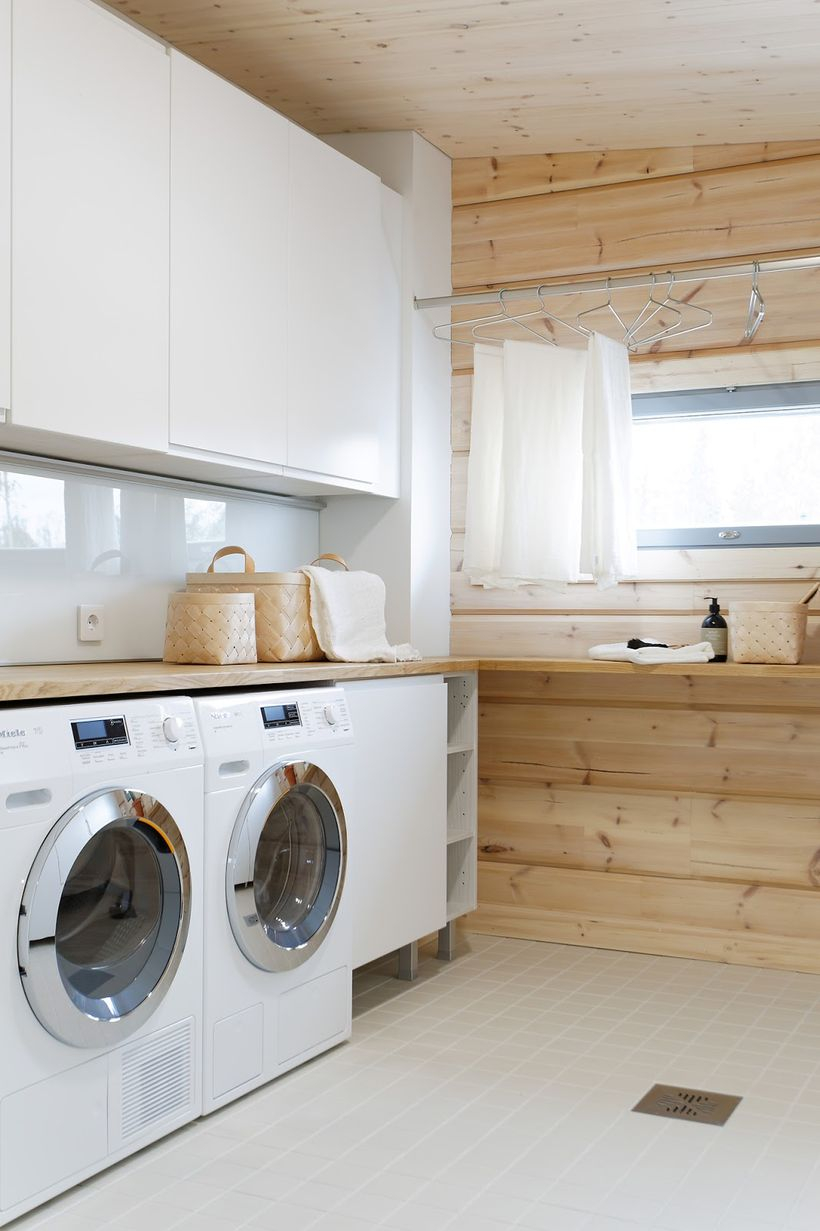 Laundry room with white cabinet and white washing machine