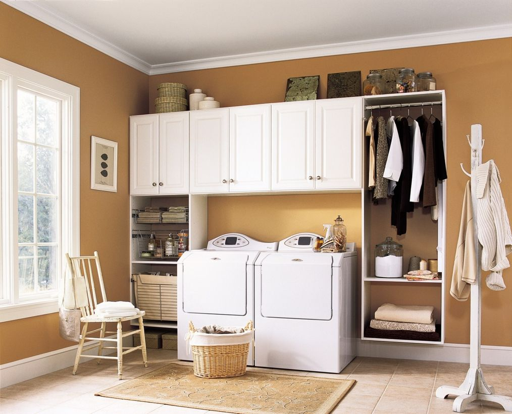 Laundry room with white cabinet, white washing machine and gray walls