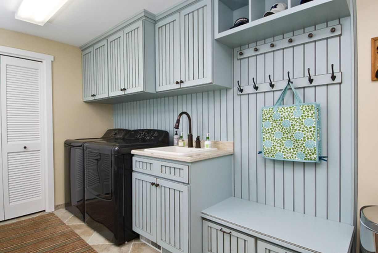 Laundry room with wooden cabinet and black washing machine