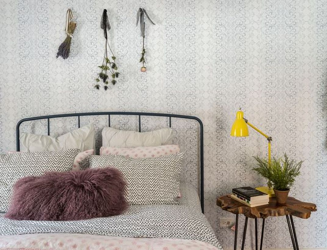 Minimalist-bedroom-with-an-iron-frame-to-show-the-boho-style-atmosphere-can-add-a-unique-night-stand-yellow-table-lamp-and-dream-catcher-for-decoration-wall