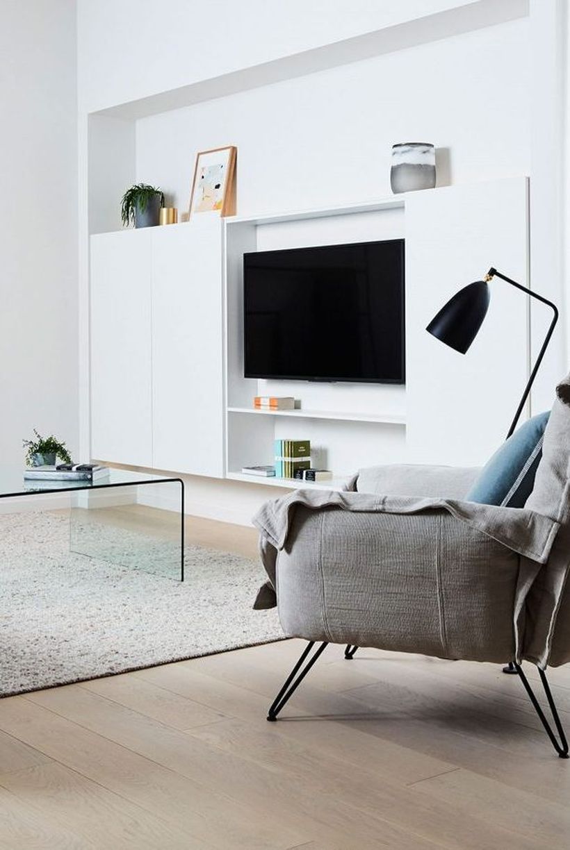 Minimalist-living-room-design-with-white-backdrop-tv-and-gray-sofa-to-relax-in-a-comfortable-family-room