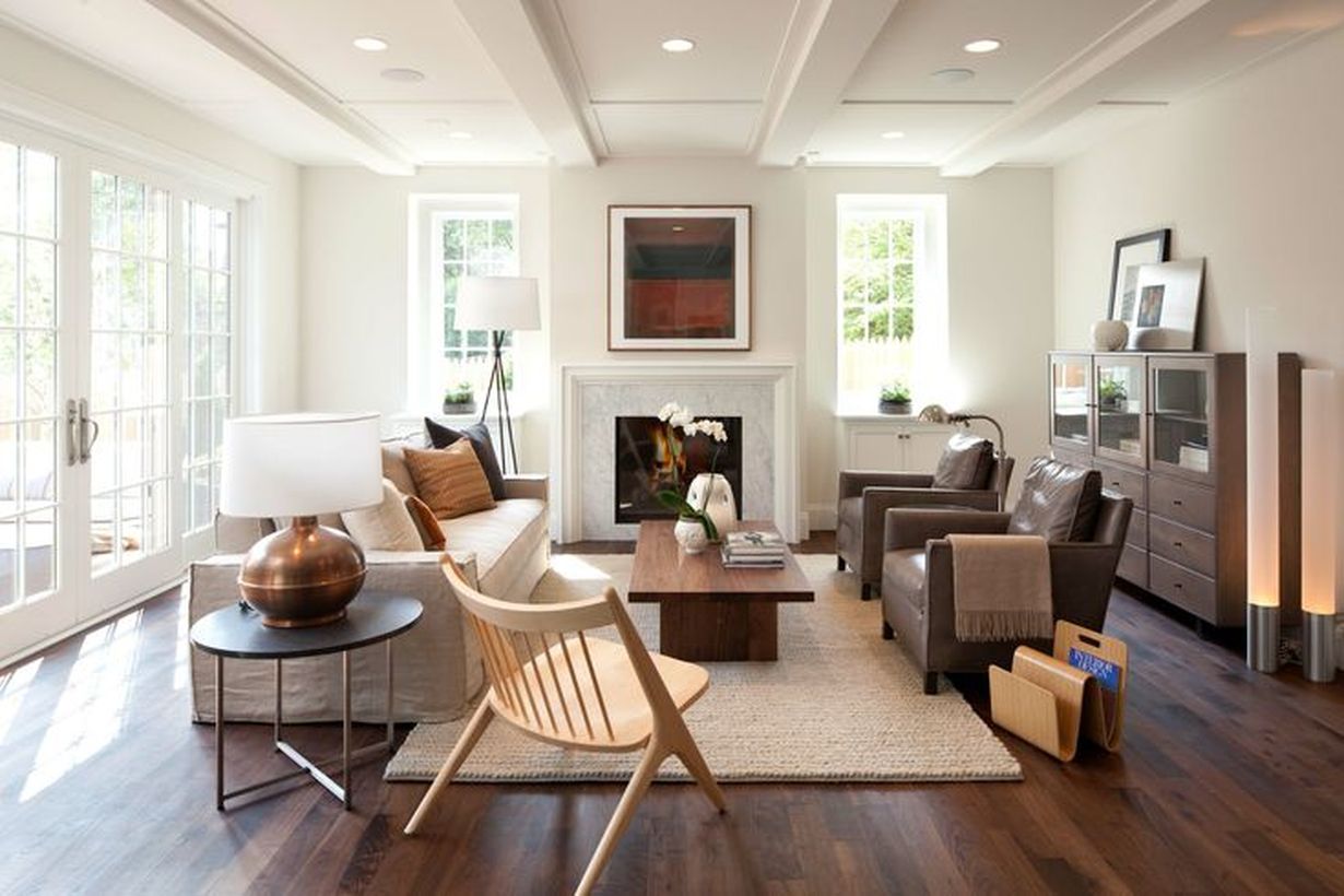 Modern-living-room-design-with-brown-leather-sofa-large-wooden-coffee-table-and-round-table-to-store-table-lamp-beside-the-sofa-to-make-it-feel-cool
