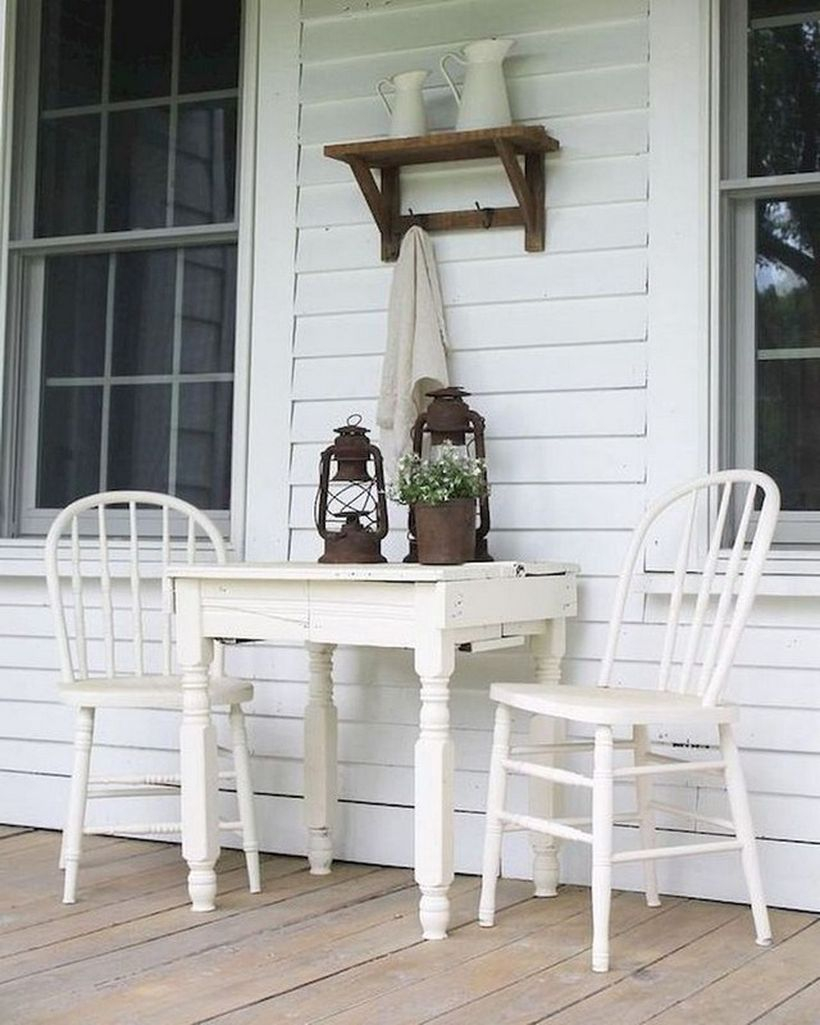 Proch with white wooden chairs and white wooden table