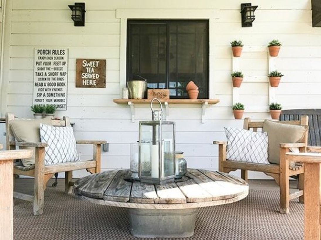 Proch with wooden chairs and a round wooden table