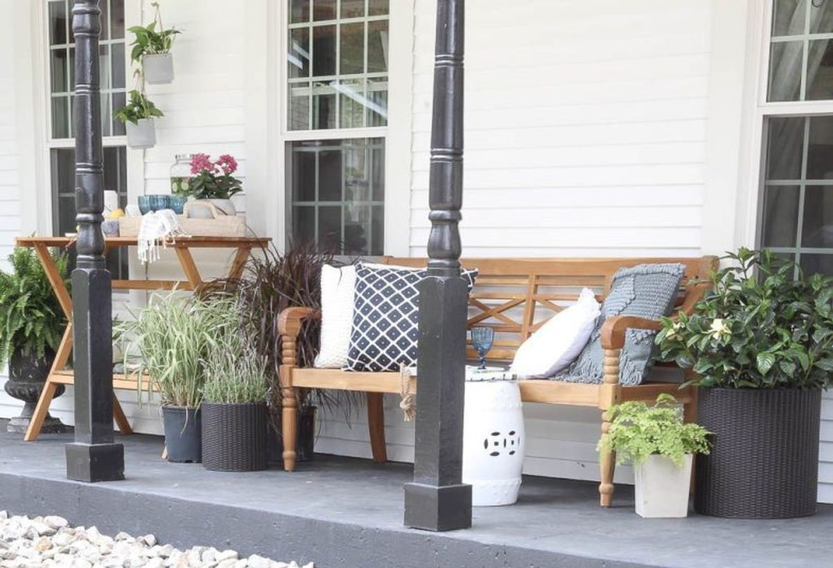 Proch with wooden chairs and plants