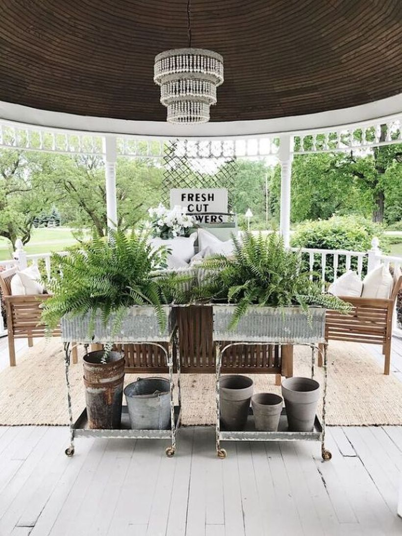 Proch with wooden furniture and green plants