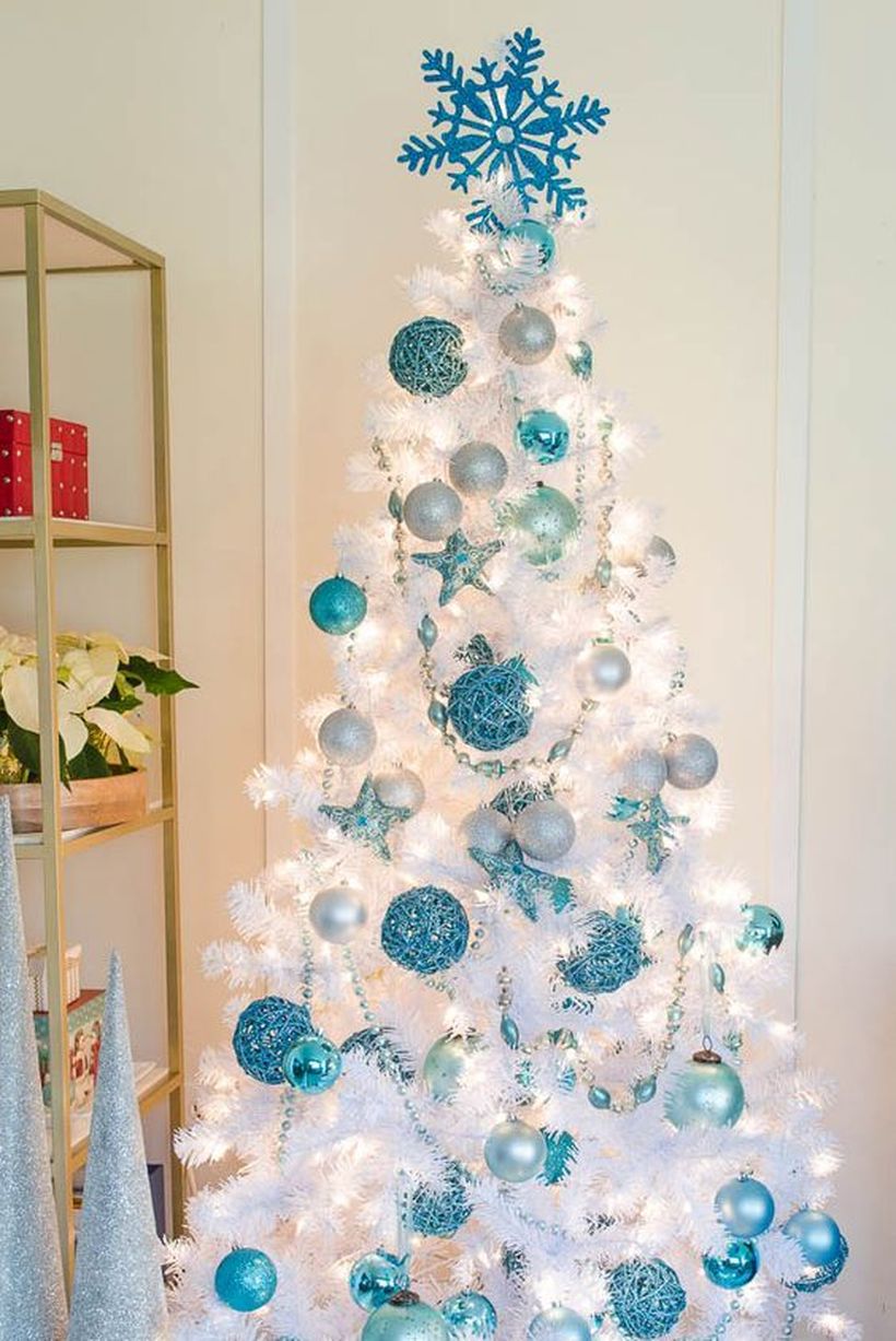 Pure-white-christmas-tree-looks-amazing-with-blue-bell-ornaments-of-various-shades-and-snow-ornaments-at-the-top