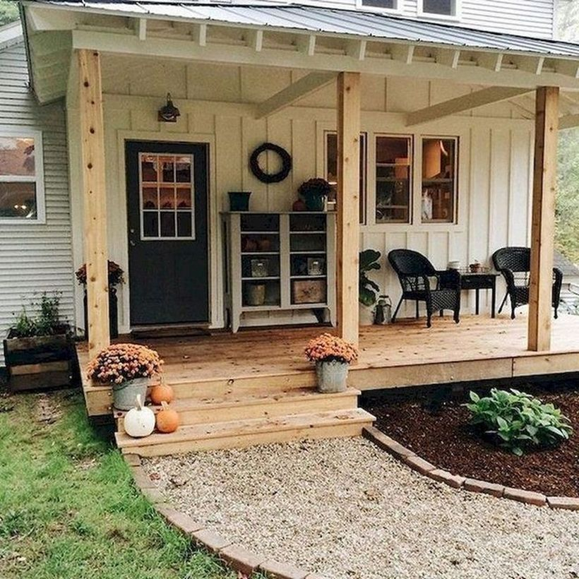 Rustic proch with black rattan chairs and plants