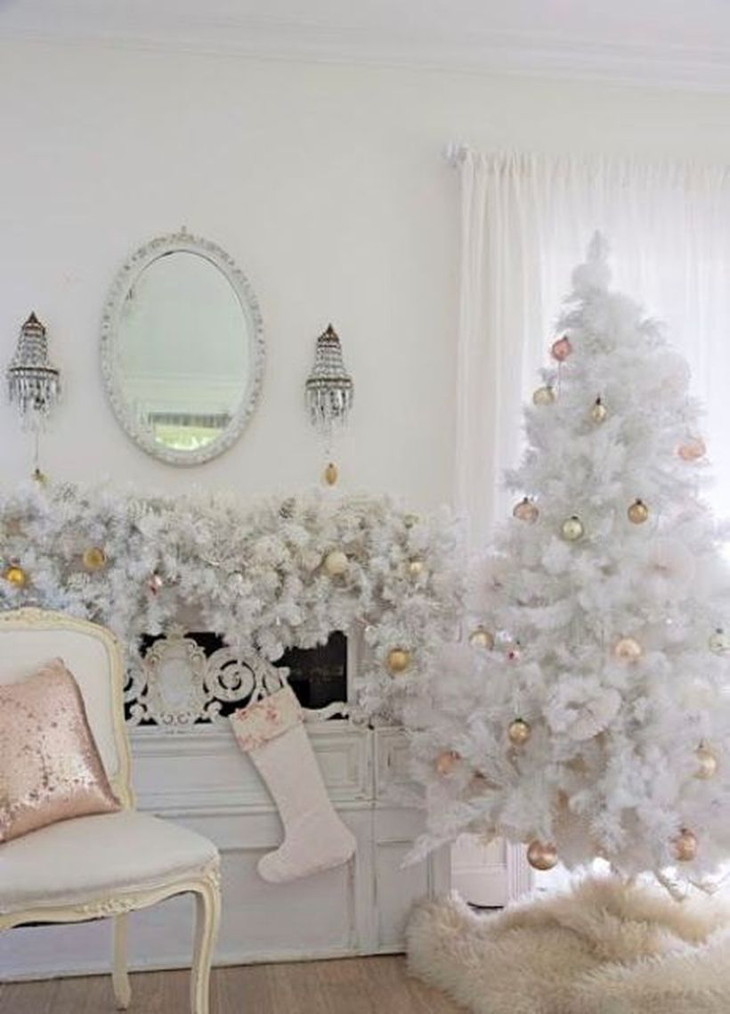 Vintage-white-christmas-tree-with-gold-ornaments-and-a-beautiful-garland-over-coat