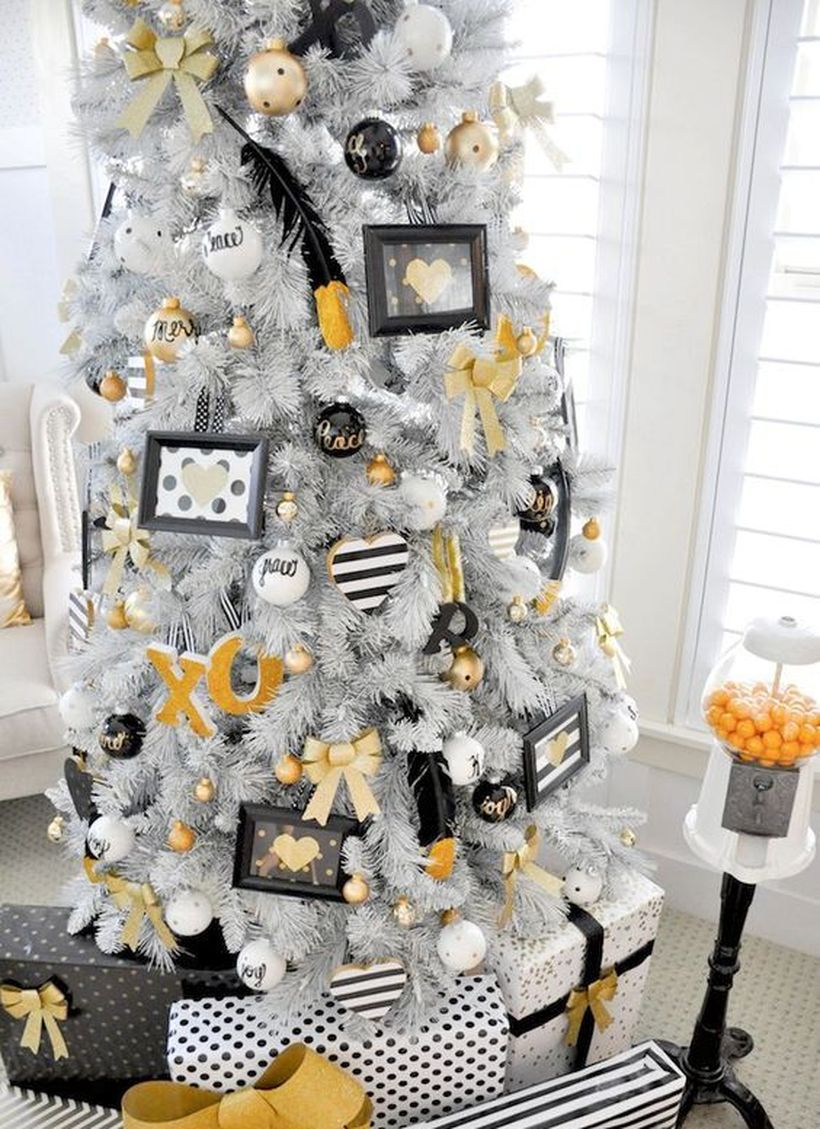 White-christmas-tree-with-various-ornaments-hung-on-the-tree-and-whimsy-white-black-and-gold-decor