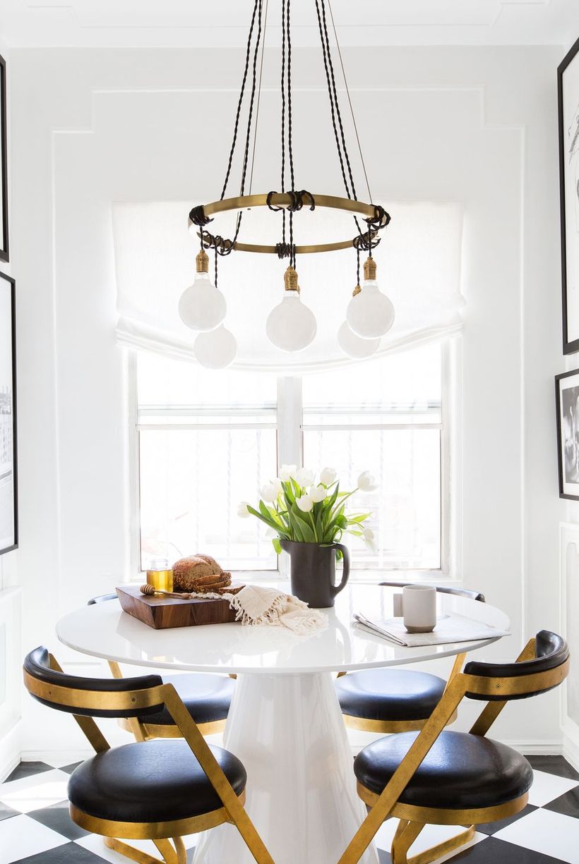 White-dining-room-design-with-round-dining-tables-unique-chandeliers-and-round-black-chairs-to-make-you-comfortable