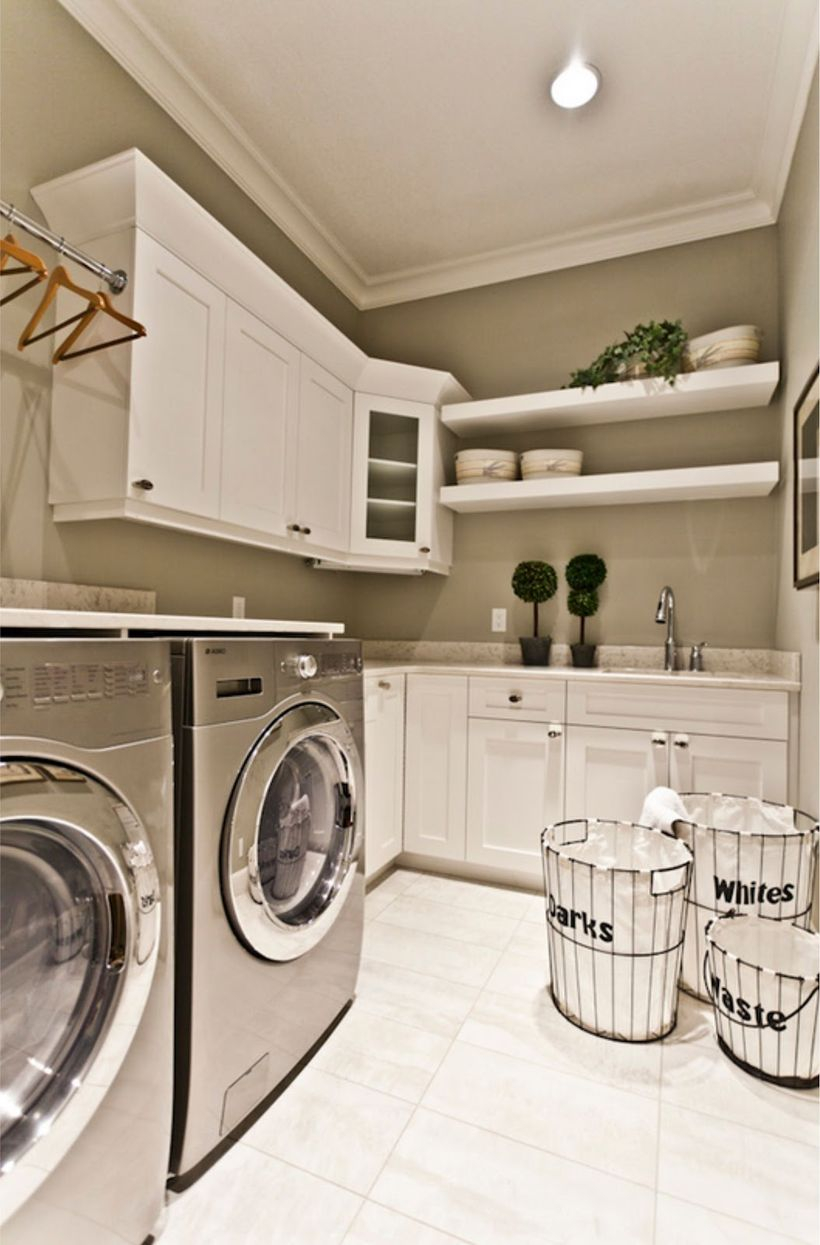 White laundry room with white cabinet and white basket