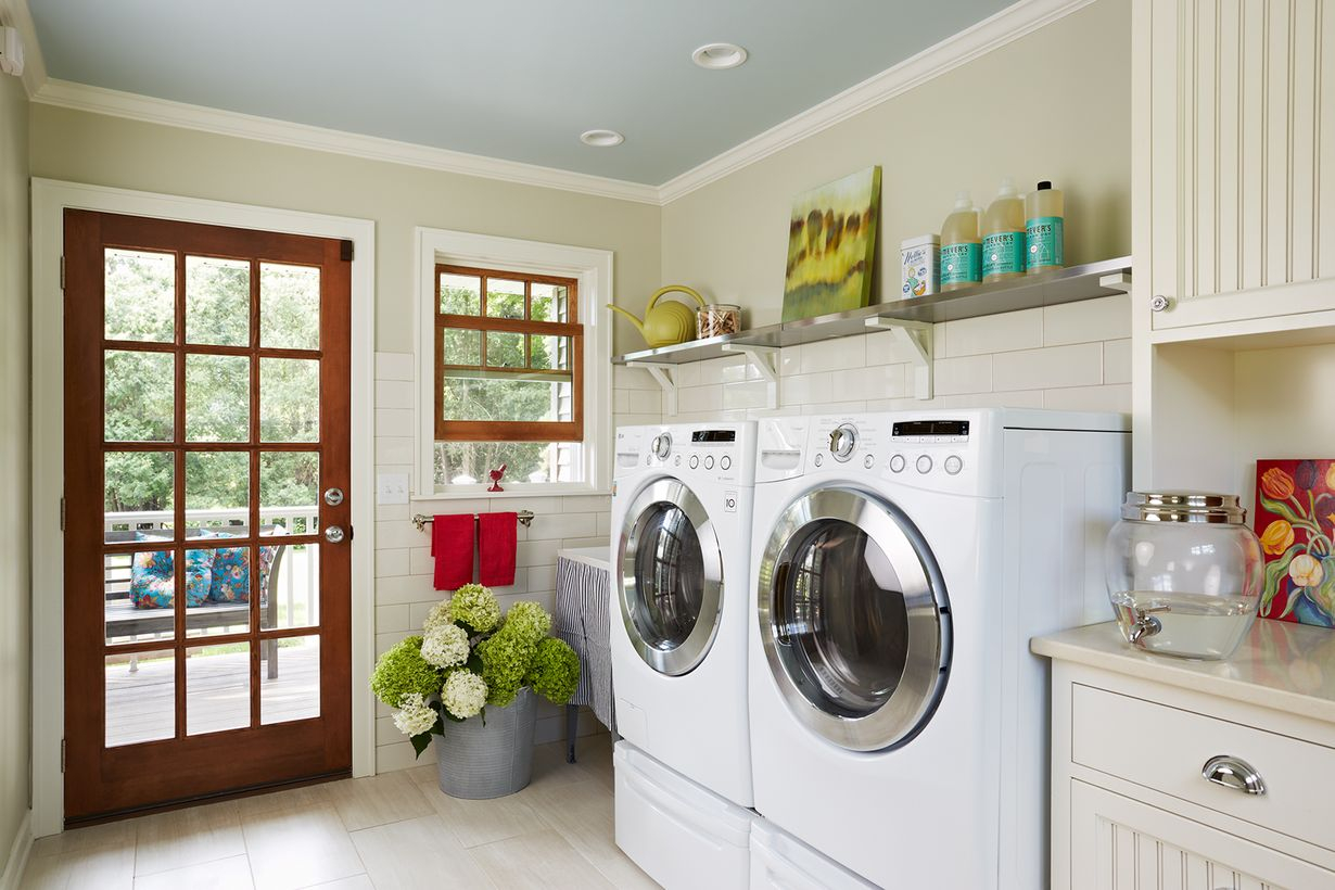 White laundry room with white cabinet and white washing machine