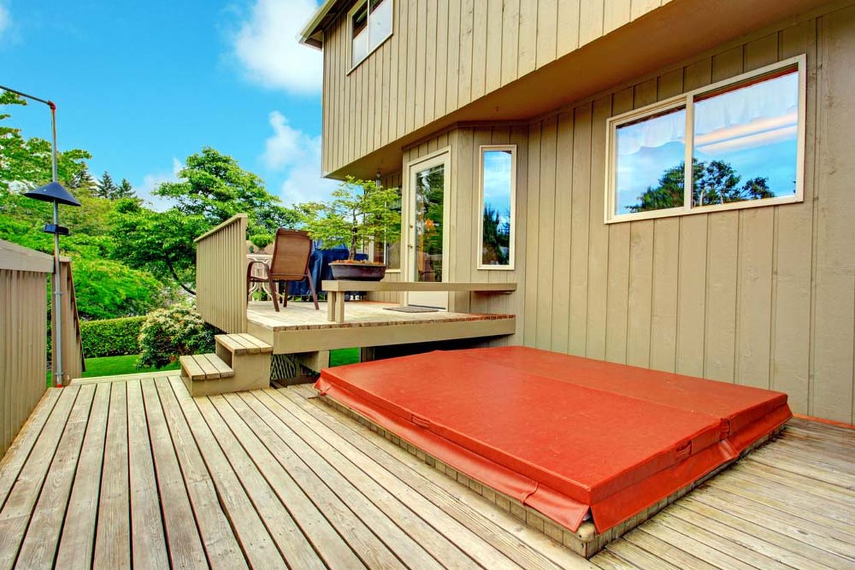Wooden-chair-and-long-bench-located-on-the-backyard-patio-deck-is-very-strategic-to-see-the-view