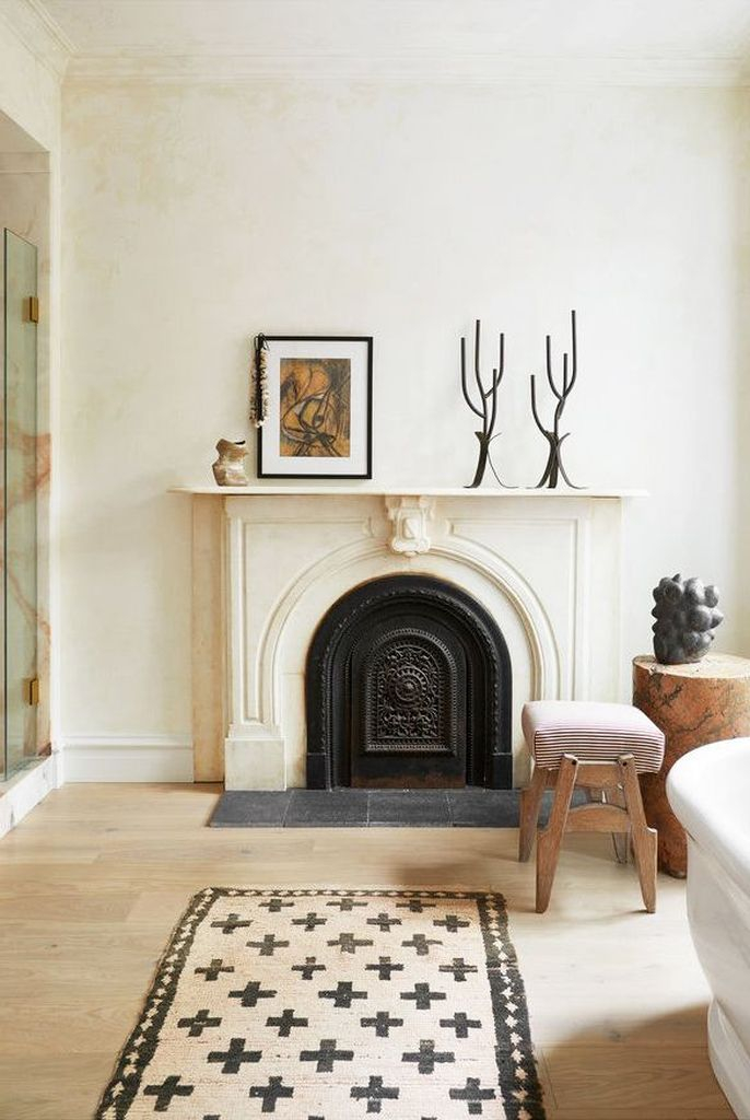 An elegant fireplace combined with candles and artwork