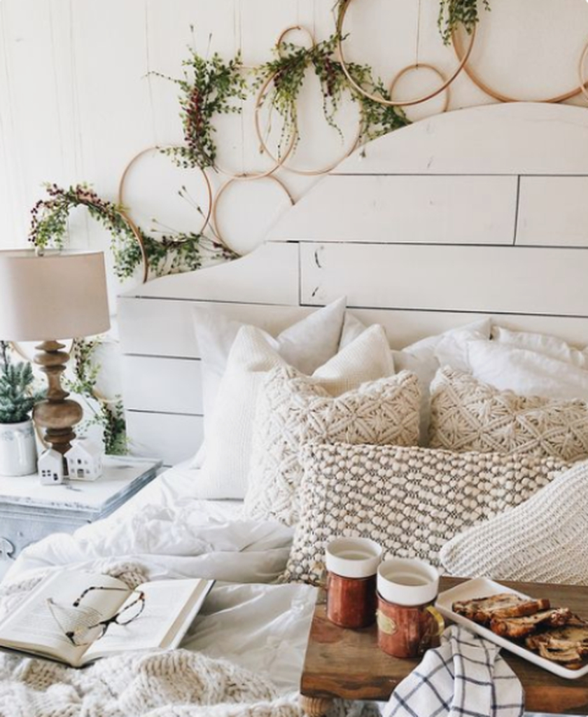 Bedroom design with greenery, knit and crochet pillows and blankets