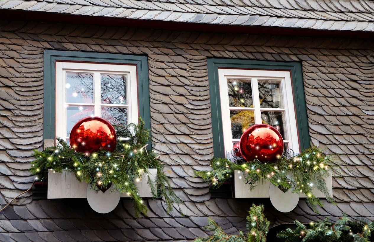 Big red ornament with green leaves and light