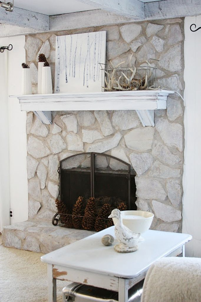 Big stone fireplace combined with floating wooden shelves