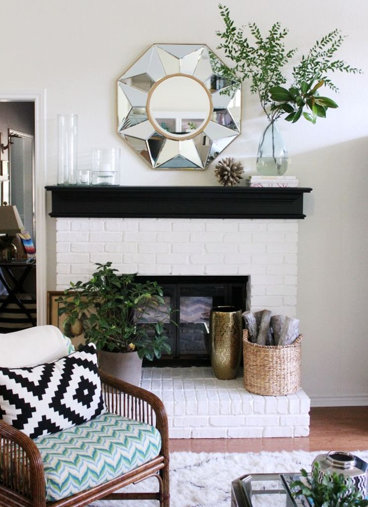 Brick fireplace combined with an elegant mirror above it