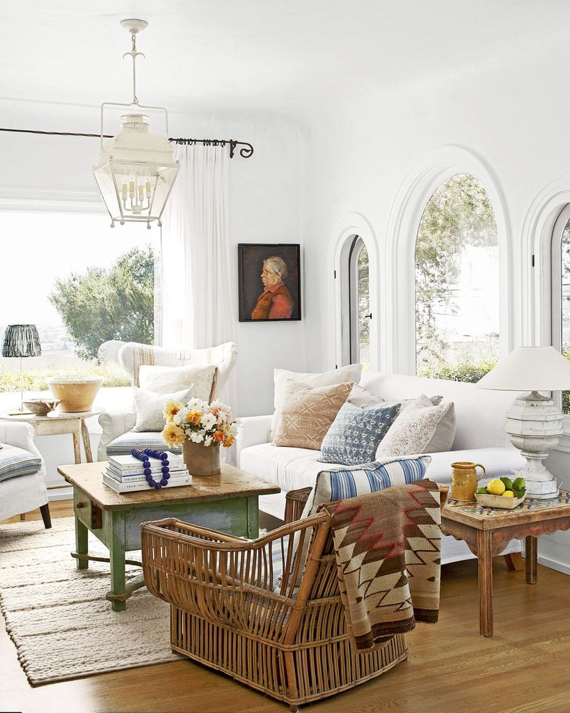 Bright farmhouse living room with wooden table, white sofa and rattan chair to make more elegant your living room