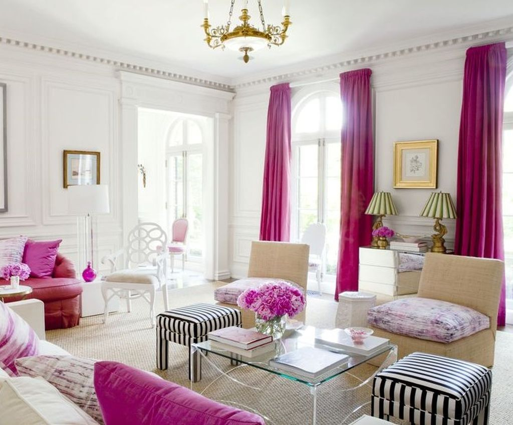 Bright living room with pink curtains and pillows
