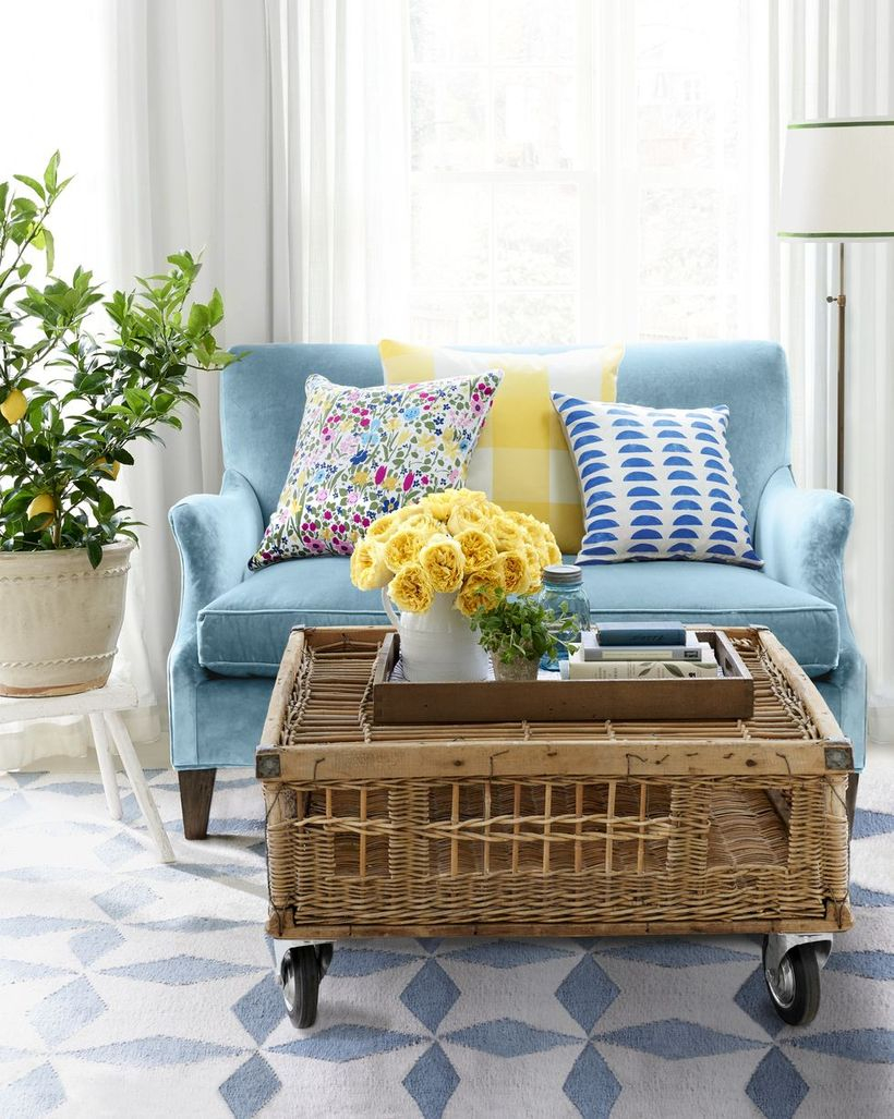Colorful pattern cushion with blue sofa and rattan table