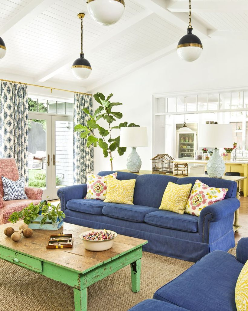 Colorful pattern cushion with blue sofa and wooden table