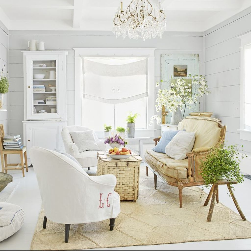 Comfy framhouse living room with woven coffee table and brown sofa combined with white chairs to perfect your living room