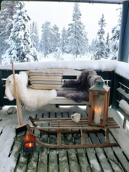 Decorate-the-balcony-with-warm-and-cozy-i’m-feeling-fuzzy-and-warm-just-looking-at-the-has-placed-a-sled-in-place-of-the-center-table.-and-the-chair-is-laid-with-furry-blankets.