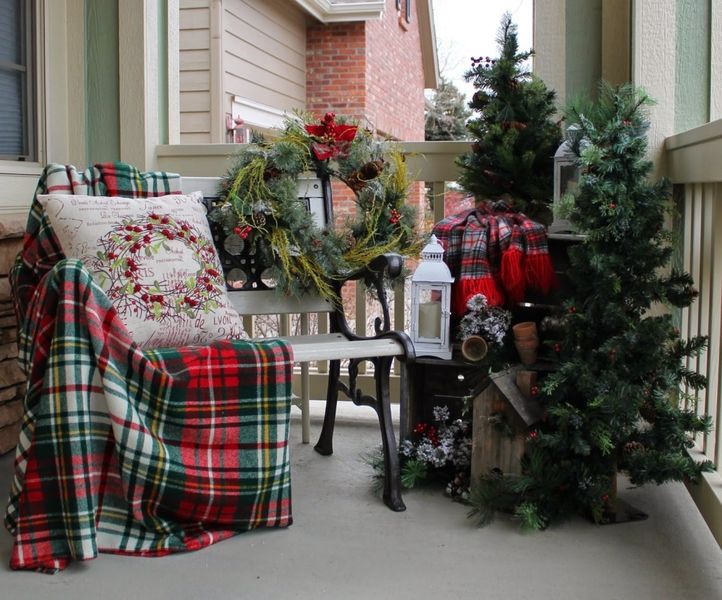 Decorate-the-balcony-with-an-outdoor-bench-laid-with-colorful-plaid-cushion-and-blanket.-you-can-even-place-a-wreath-at-the-opposite-end.