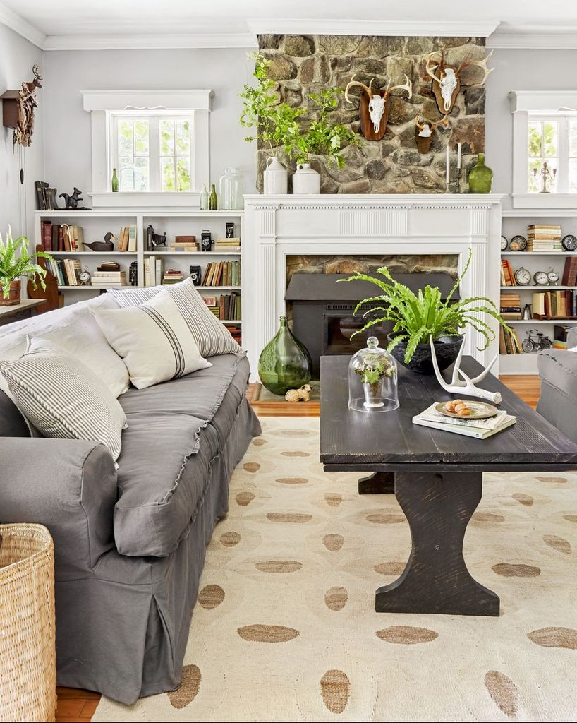 Farmhouse living room with dark grey sofa and black wooden table to perfect your living room design