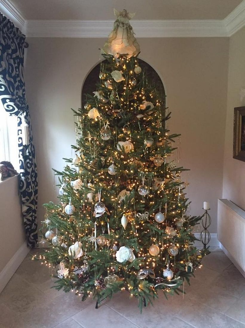 Green chrismast tree with white ornament and yellow light