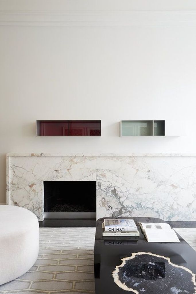 Marble fireplace and glossy floating shelves
