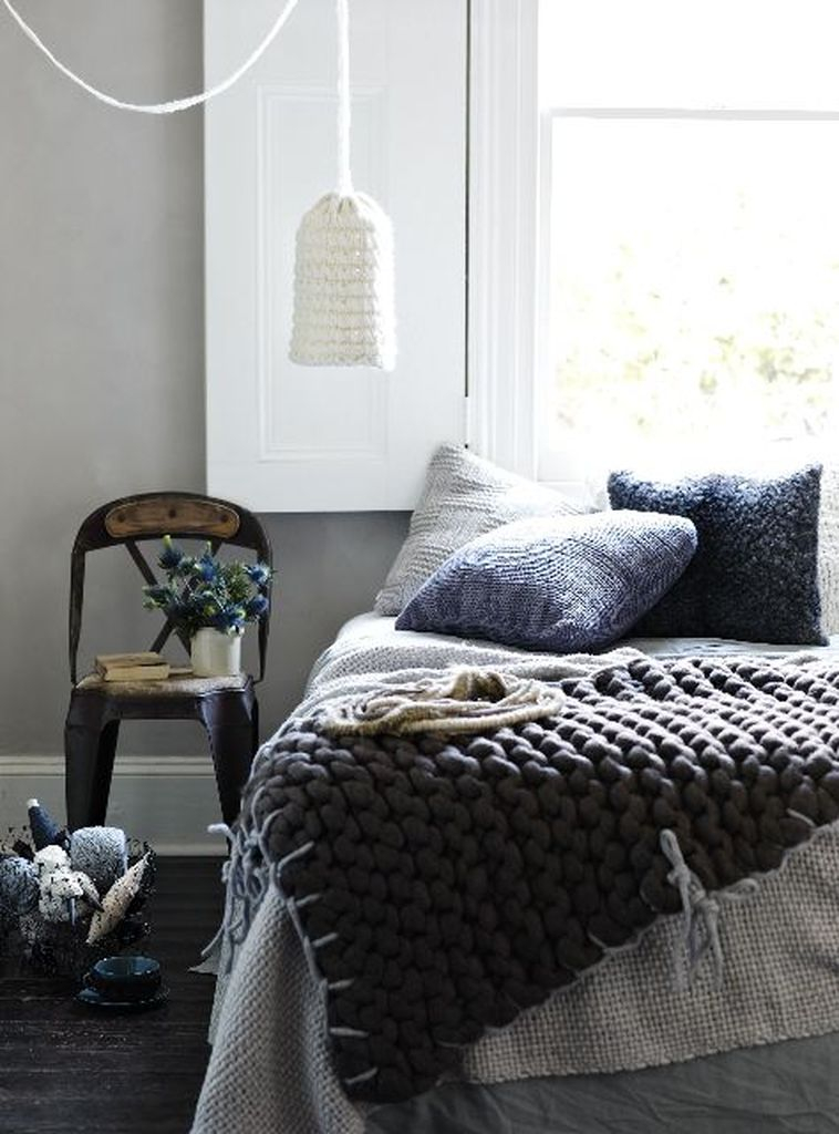 Modern bedroom design with knit pillows in various shades